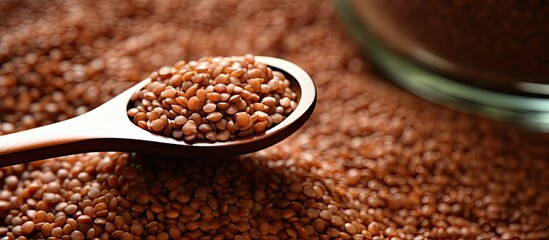 Brown lentils on a spoon on a table