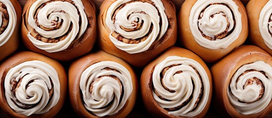 Obraz na płótnie Canvas A tray of sweet cinnamon rolls topped with frosting