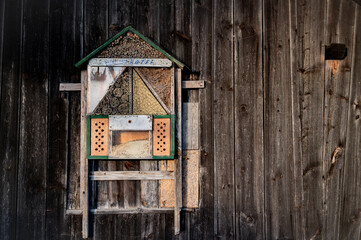 Bernstein, Austria 09.16.2023  hotel for wild bees. Antique wood background, with textures and corrosion. Rustic raw style