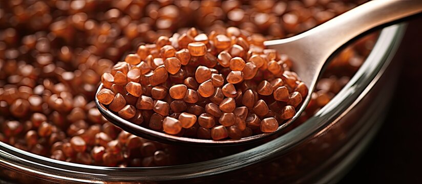 A tablespoon filled with brown sugar grains