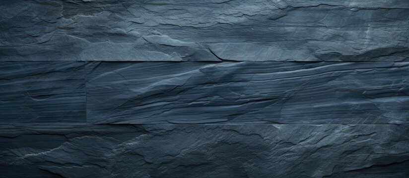 Close-up of textured black stone wall with fine lines