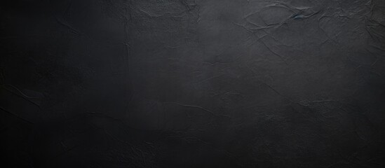 Close-up of black wall with silver knife and fork - obrazy, fototapety, plakaty