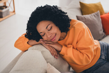 Photo portrait of lovely young lady closed eyes lean on sofa sleepy dressed casual orange clothes...