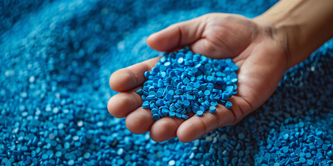 Hand Holding Blue Plastic Resin Pellets for Plastic Manufacturing, Overmolding, Low Pressure Overmolding, and Injection Molding Materials