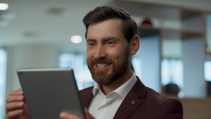 Excited man receiving message at modern lobby closeup. Person winning gesture