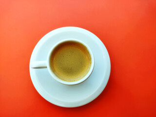 Cup of coffee and Pyrex on the red background 
with copy space for design. Ready template, banner  Business presentation