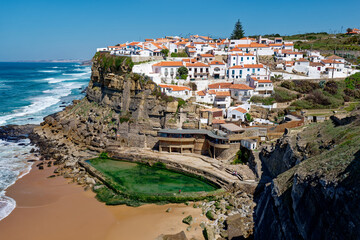 Azenhas do Mar, Portugal. Natural pool in the ocean, next to the cliff and a seaside village...