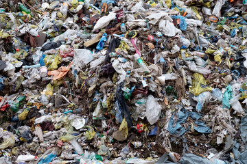 Landfill with garbage in nature. Plastic waste. Environmental issue.
