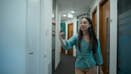 Fototapeta na wymiar Closeup attractive employee using phone at office. Woman talking smartphone