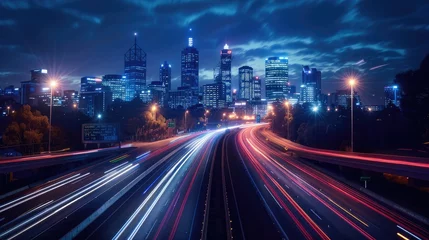  City at night, with its iconic skyline illuminated against a deep blue sky, featuring a bustling highway overpass adorned with motion-blurred cars traversing the scene. © lililia