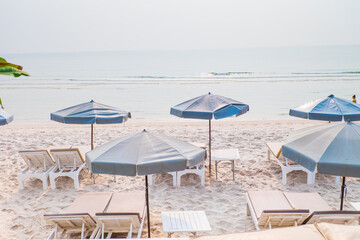 Rows of sun loungers and umbrellas on sandy beach in Tropical Beach,vacation concept.