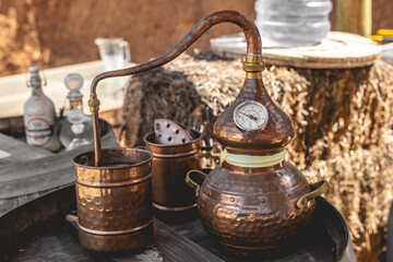 Artisan distillation: the timeless craft of a copper alembic still poised atop an aged wooden barrel