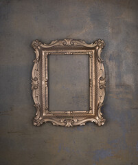 golden ancient dusty frame on a concrete wall