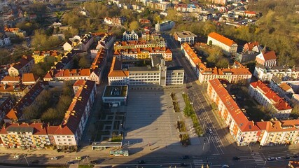 Aerial view of Koszalin city center during the "golden hour" with cathedral, Victory Street, and town hall.