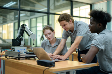 Fototapeta premium Trainee Robotics engineer learning with Programming and Manipulating Robot Hand, Industrial Robotics Design, High Tech Facility, Modern Machine Learning. Mass Production Automatics.