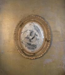 vintage dusty mirror on a concrete wall
