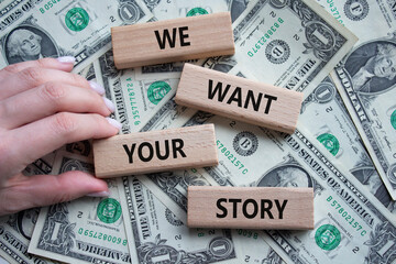 We want your story symbol. Concept words We want your story on wooden blocks. Businessman hand....