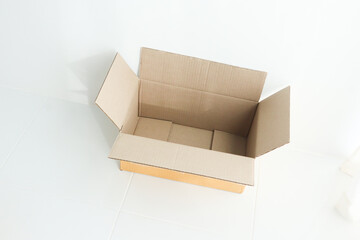 Open cardboard box on white background,delivery unboxing concept.