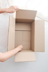Open cardboard box on white background.