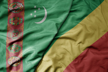 big waving national colorful flag of republic of the congo and national flag of turkmenistan.
