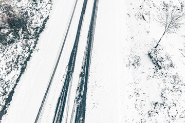 drone aerial view of a road in a snowy landscape, winter time transportation concept - Powered by Adobe