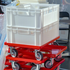 Stack of White Plastic Crates at Skid Wheels Cart Transportation