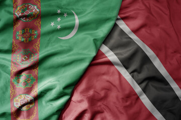 big waving national colorful flag of trinidad and tobago and national flag of turkmenistan.