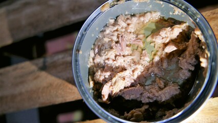 A tuna can close-up shot. A fresh can of tuna on the table. A bowl of tuna. Cooking at home....