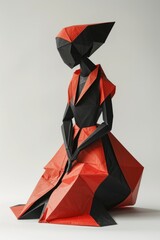 A black and red paper sculpture of a woman.