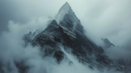 Snow-Covered Tall Mountain Under Cloudy Sky