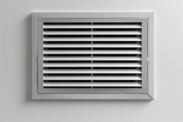Detailed view of a vent on a wall, showing the metal grille and surrounding surface.