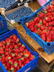 blue boxes with strawberries and blueberries - obrazy, fototapety, plakaty