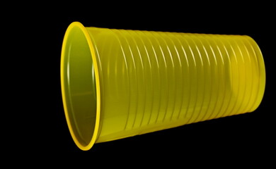 Empty new yellow disposable plastic cup isolated on black, clipping path - 764291634
