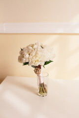 Mono bridal bouquet of white peonies. Vertical wedding banner. Selective soft focus, copy space