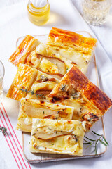 Puff pastry pie with cheese, pears, nuts and honey, served with champagne. - 764294630