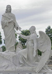 Marble kneeling angel and Jesus Christ sculpture atop a tomb, Avenida Cristobal Colon Avenue west side, Cementerio de Colon Cemetery. Havana-Cuba-093