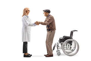 Female doctor giving support to an elderly male patient with a wheelchair