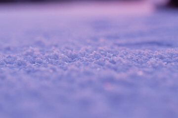 Close up of a purple snowcovered surface under a violet sky