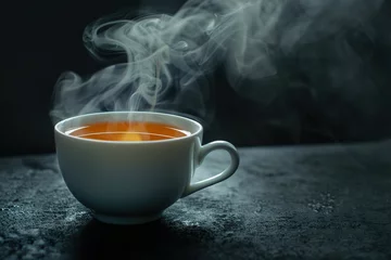 Schilderijen op glas Cup of tea with steam on dark background © Alina