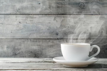  Cup of tea with steam on wooden table © Alina