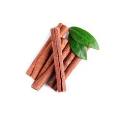 Cinnamon sticks and green leaves isolated on white, top view