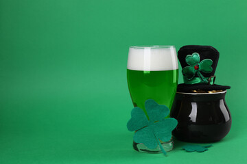 St. Patrick's day party. Green beer, leprechaun hat, pot of gold and decorative clover leaves on...
