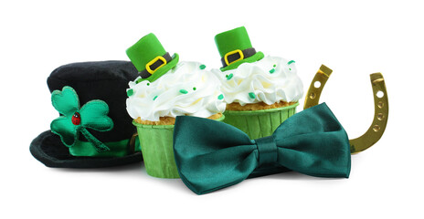 St. Patrick's day party. Tasty festively decorated cupcakes, green bow tie, gold horseshoe and...