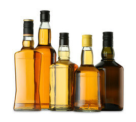 Different sorts of whiskey in glass bottles isolated on white