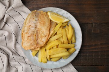 Delicious fish and chips on wooden table, top view