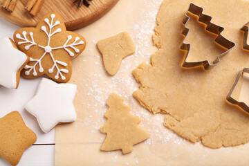 Making Christmas cookies. Flat lay composition with raw dough on white wooden table