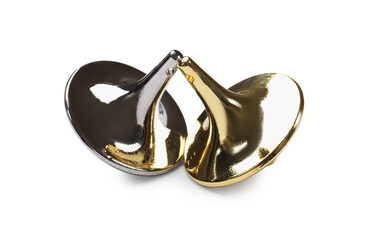Golden and silver spinning tops on white background