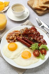 Delicious breakfast with sunny side up eggs on light table