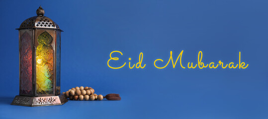 Eid Mubarak banner. Arabic lantern and misbaha on blue background