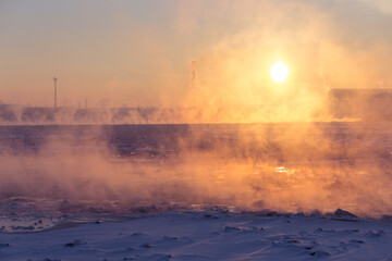 Water emitting smoke, sunset over snowy plain with red sky afterglow